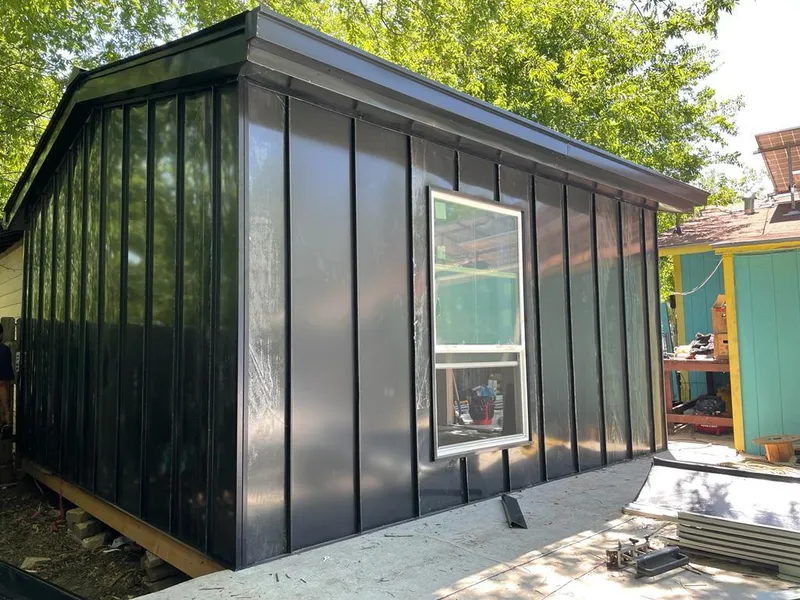 Black standing seam metal wall panels for Roof Inspection in Collinsville